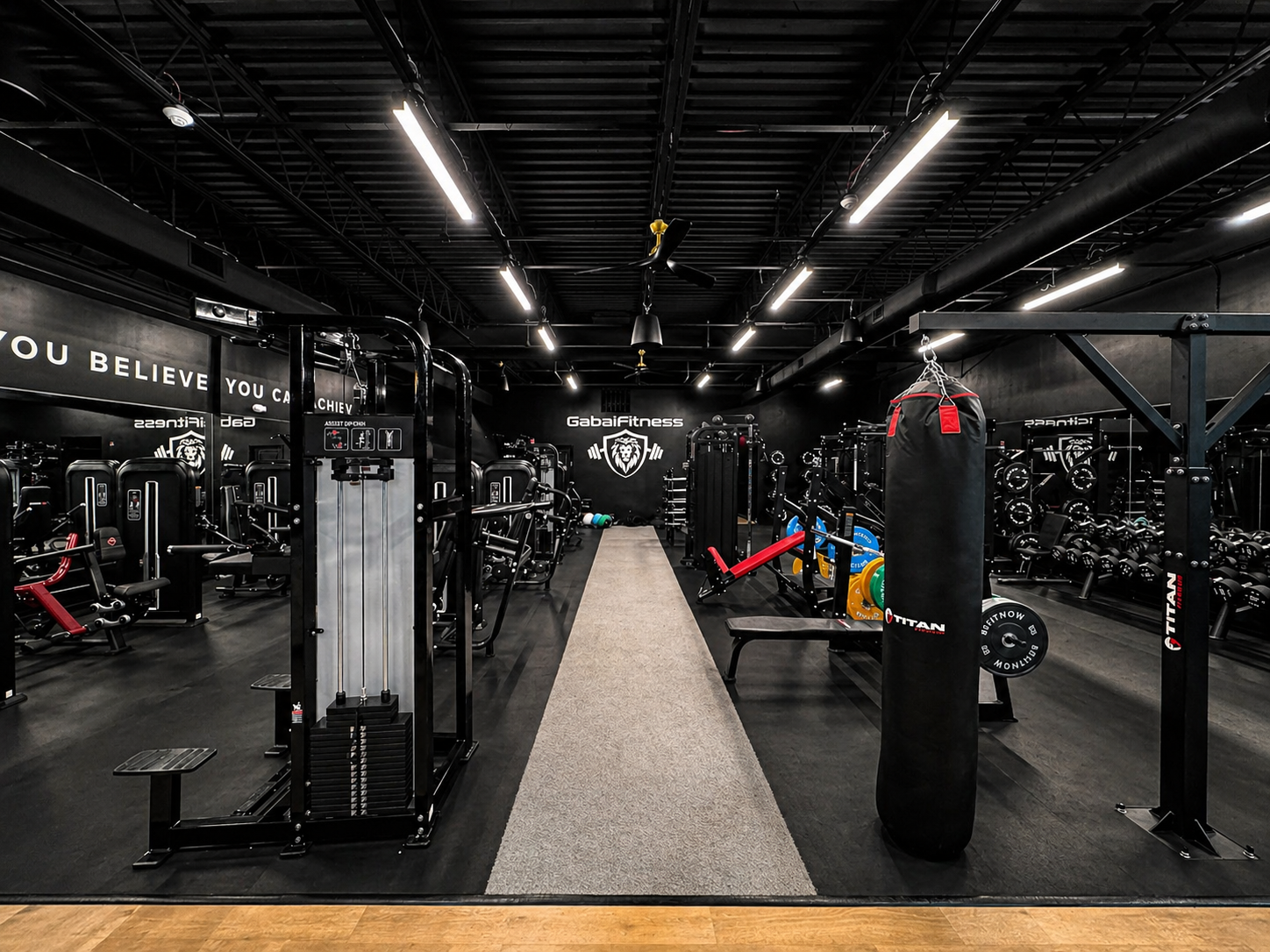Central training aisle flanked by cable machines and a heavy bag